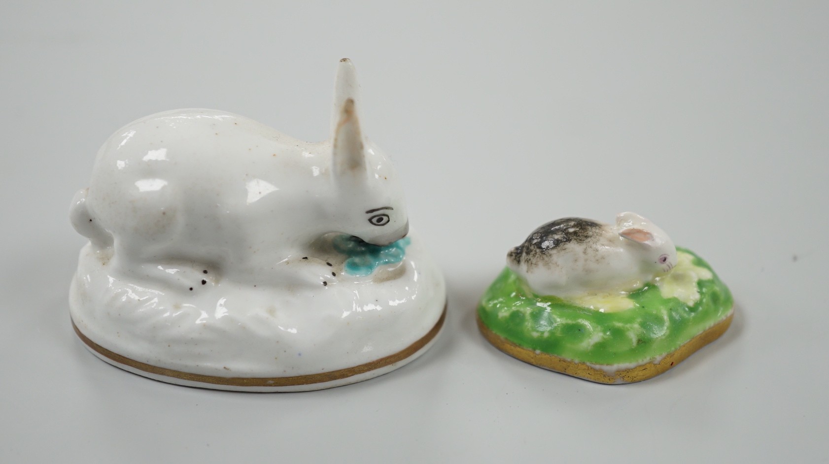 Two toy Staffordshire models of a recumbent rabbit and a bunny, both on oval bases, c.1830-50, (2). Tallest 4cm, Provenance Dennis G.Rice collection